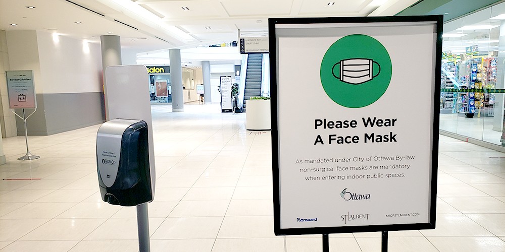 aggressive customers - Please wear a mask sign in shopping mall entrance